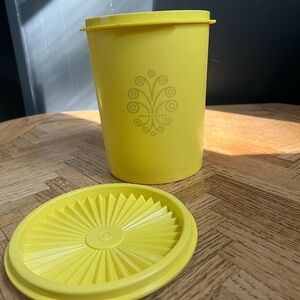 Vintage Tupperware canister with sunburst lid in daffodil yellow; medium